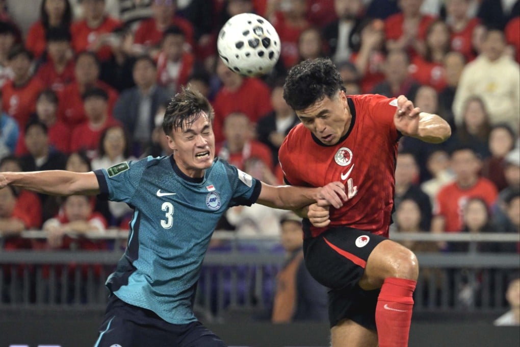 Leon Jones (right) of Hong Kong vies with Ryhan Stewart of Singapore during the Asian Cup Qualifiers third round group C match in Hong Kong, on November 18. Photo: Xinhua