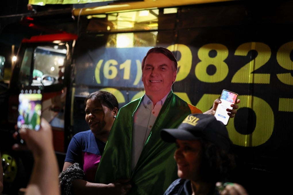 A person holds a cut-out of Brazil’s former president Jair Bolsonaro during a vigil in Brasilia on Saturday. Photo: Reuters