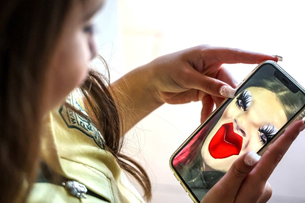 Bianca Navarro, 10, looks at a screenshot of herself from Snapchat at her home in Sydney on October 30. Photo: AFP