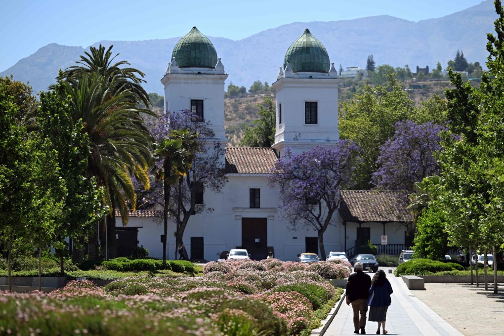 People walk near a church in the commune of Las Condes, in Santiago, Chile on November 12. Photo: AFP