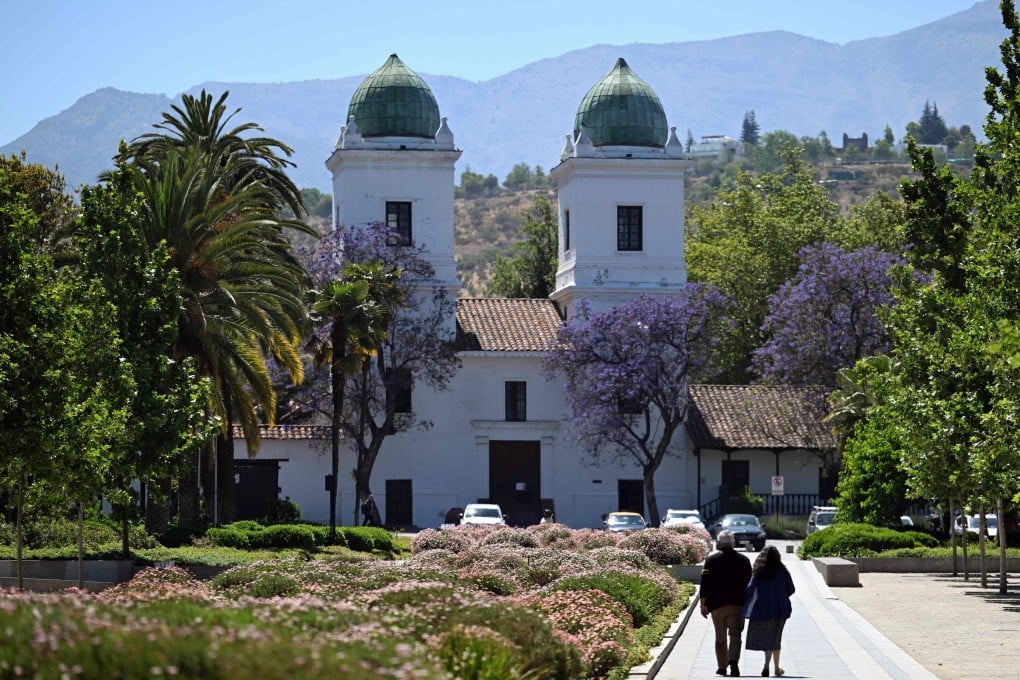 People walk near a church in the commune of Las Condes, in Santiago, Chile on November 12. Photo: AFP
