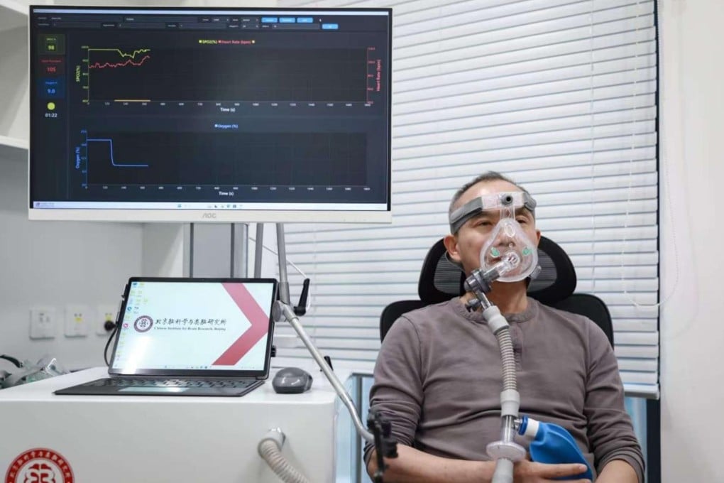 Luo Minmin from the Beijing Institute for Brain Research tests the acute intermittent hypoxia device developed by his team. Photo: Handout