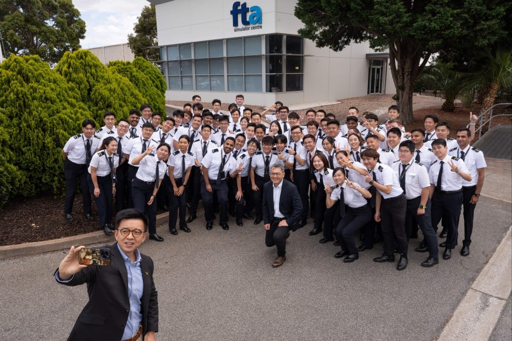 Cathay Group CEO Ronald Lam Siu-por takes a selfie with Director-General of Civil Aviation Captain Victor Liu and Cathay pilots at Flight Training Adelaide. Photo: Handout