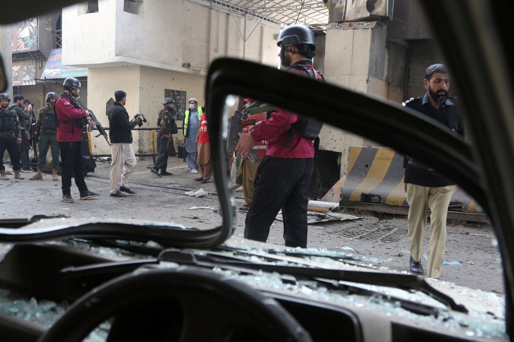 Paramilitary soldiers secured the entrance of their headquarters in Peshawar, Pakistan, on Monday after suicide bombers attacked it. Photo: Reuters