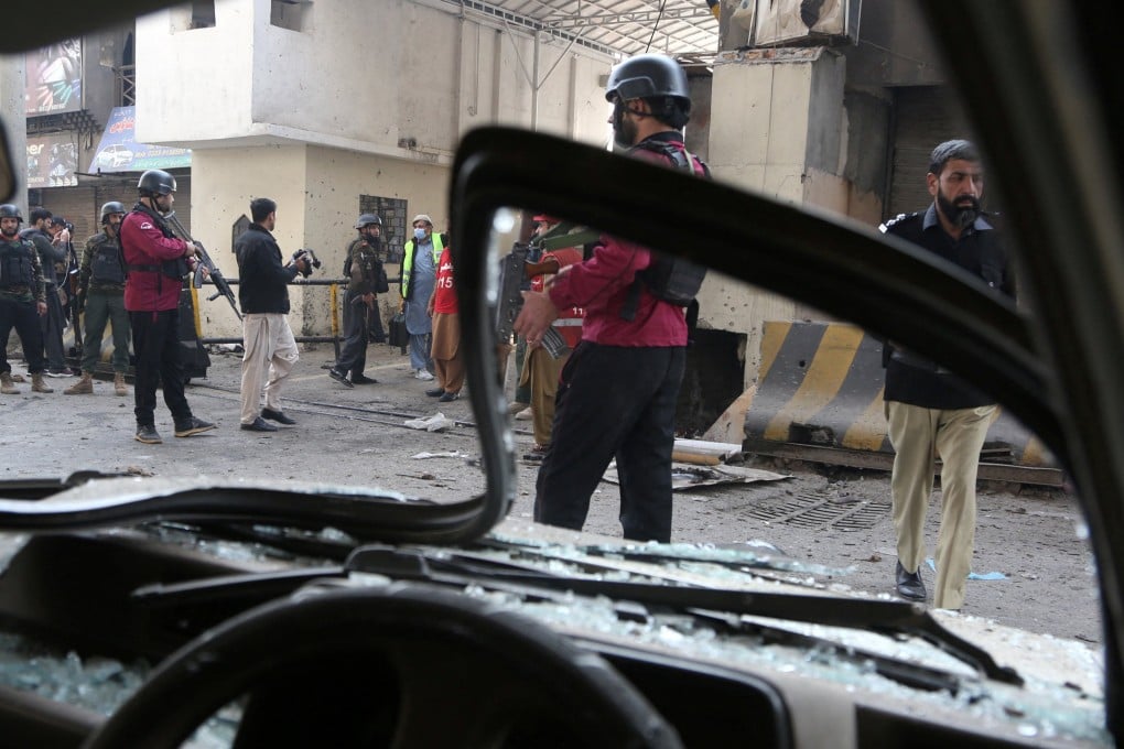 Paramilitary soldiers secured the entrance of their headquarters in Peshawar, Pakistan, on Monday after suicide bombers attacked it. Photo: Reuters