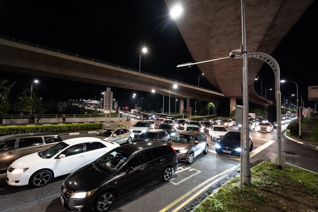 Cars queue up at Woodlands Checkpoint in Singapore. A Singapore private-hire driver has denied that a racist message on his car’s display system originated from him. Photo: Anadolu Agency via Getty Images