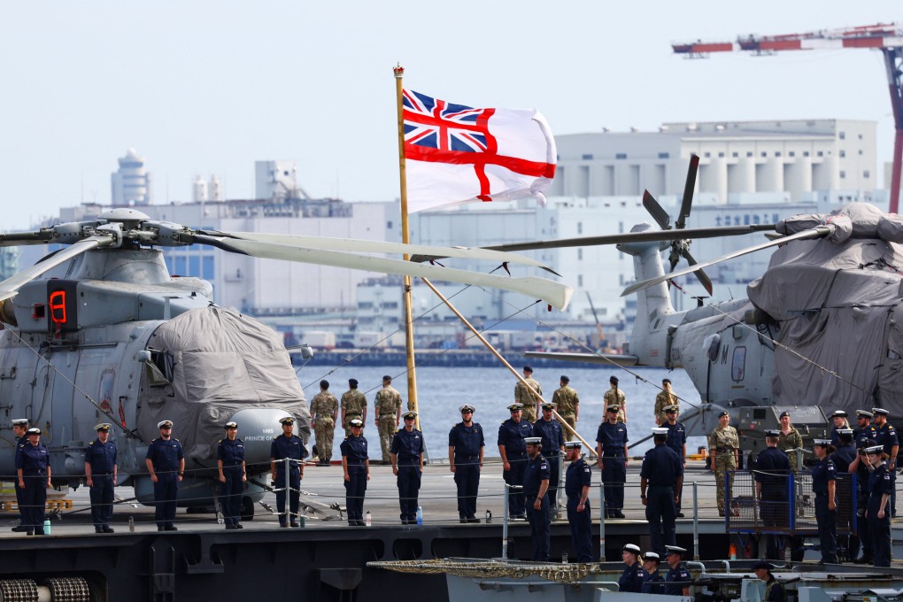 UK military personnel stand on board Britain’s HMS Prince of Wales aircraft carrier as it arrives in Tokyo, Japan, in August. Photo: Reuters