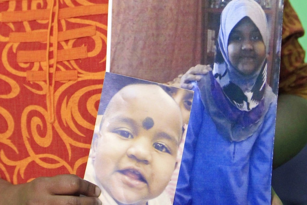 In this 2014 photo, M. Indira Gandhi shows photos of her youngest daughter Prasana Diksa at her house in Ipoh, Perak, Malaysia. Photo: AP