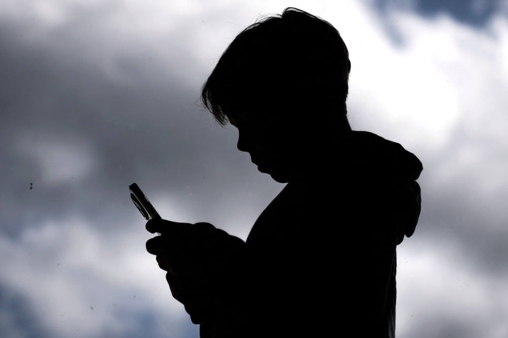 A 14-year-old boy browses social media on his phone. Starting December 10, Australia will mandate that social media platforms remove users under 16. Photo: AFP