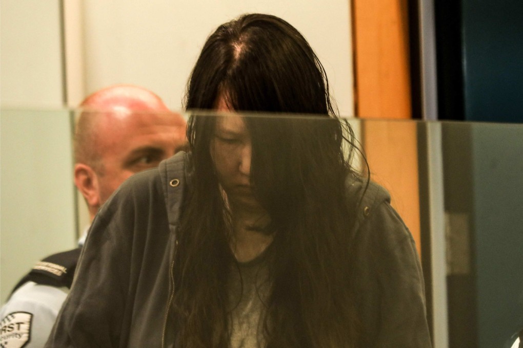 Lee Hak-yung looks down during her sentencing to life imprisonment for the murder of her two children at Auckland High Court in New Zealand on Wednesday. Photo: AFP