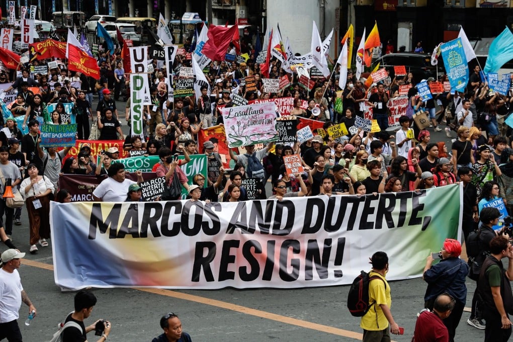 Protesters hold a banner calling for the resignation of Philippine President Ferdinand Marcos Jnr and Vice-President Sara Duterte during an anti-corruption rally in Manila on November 21. Photo: EPA