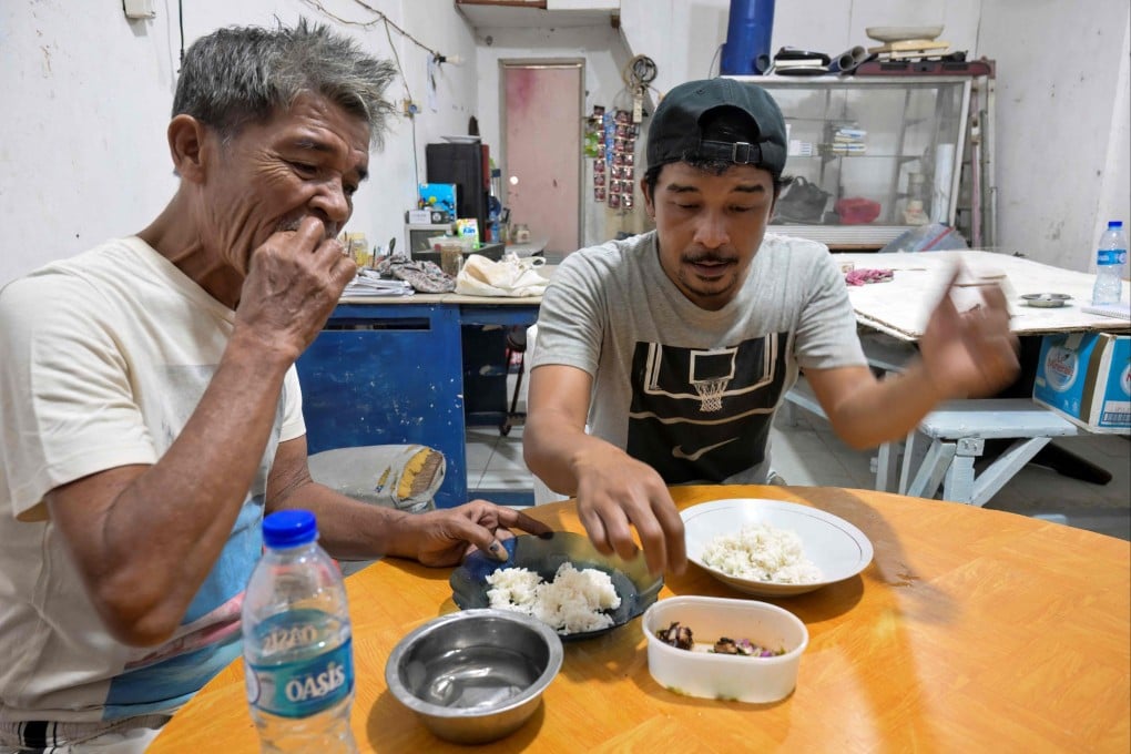 People enjoy a dish made from dog meat at a food stall in Jakarta on November 12. Photo: AFP