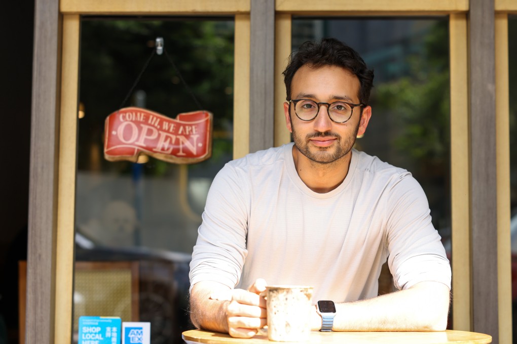 Ali Abdaal, a former doctor who is now a digital creator, entrepreneur and YouTube star, sits at a cafe in Causeway Bay. Abdaal will speak at the Hong Kong Jockey Club Amphitheatre on December 8 to explain how to make 2026 “the best year of your life”. Photo: Nora Tam