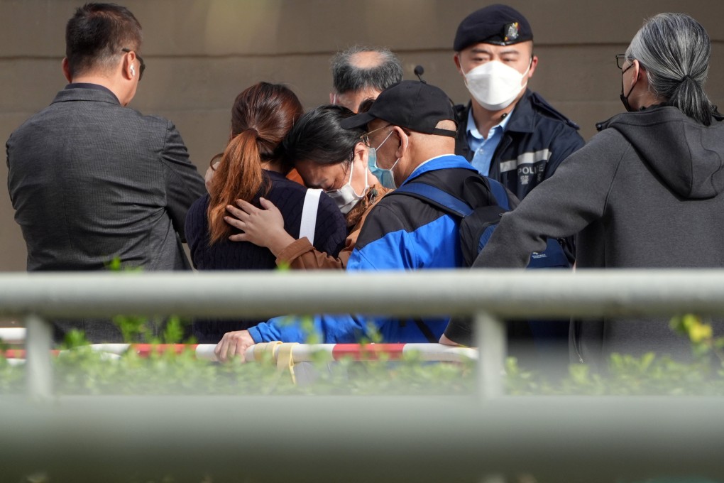 People identify deceased relatives at Kwong Fuk Community Hall after the fatal fire at Wang Fuk Court in Tai Po. Photo: Eugene Lee