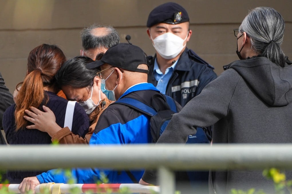 People console each other after identifying deceased relatives at Kwong Fuk Community Hall following the fatal fire at Wang Fuk Court in Tai Po, on November 27. Photo: Eugene Lee