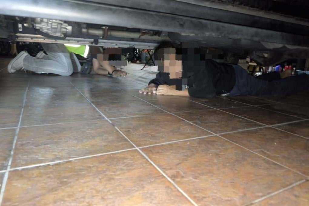 The victim was forced to hide under a vehicle to avoid detection during a raid in in Batu Caves, Malaysia. Photo: Facebook/imigresen