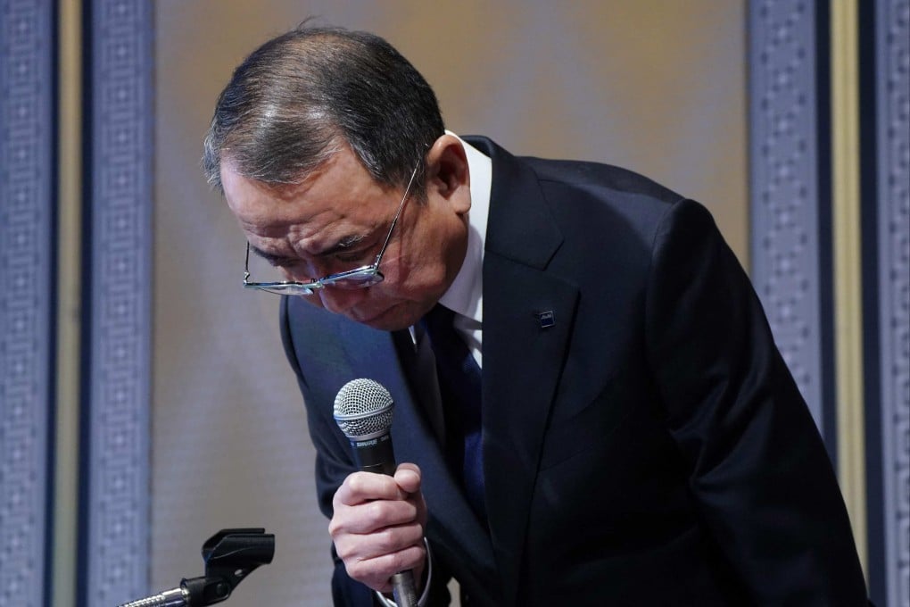 Asahi Group Holdings president Atsushi Katsuki bows in apology at a press conference in Tokyo on Thursday. Photo: AFP