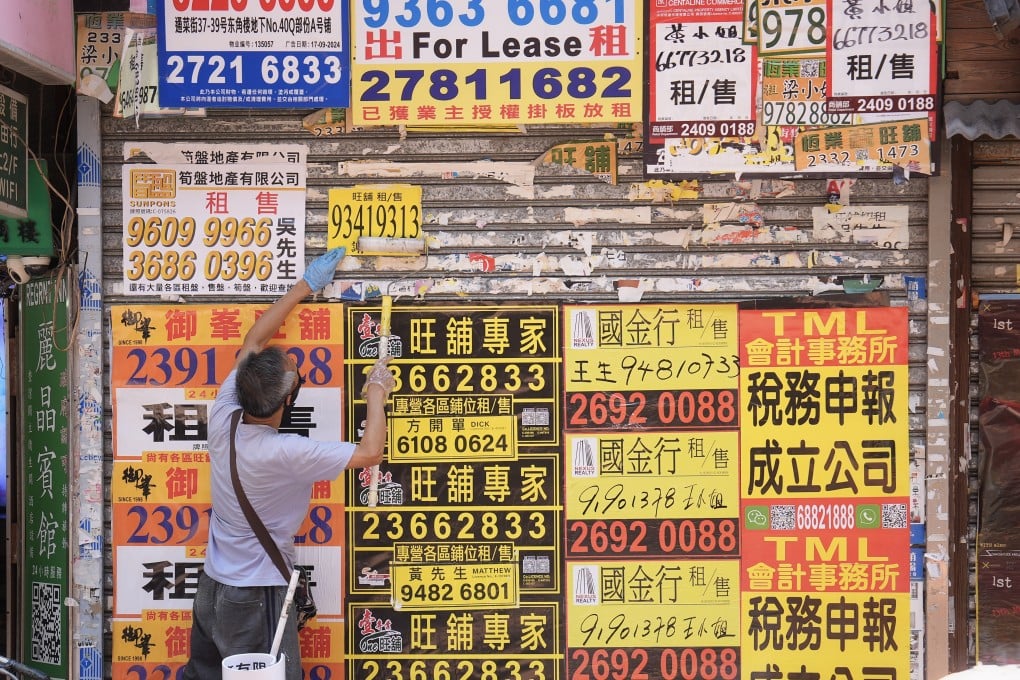A worker sticks up another rental advertisement on the shutter of a vacant shop in Mong Kok on May 2. Photo: Elson Li