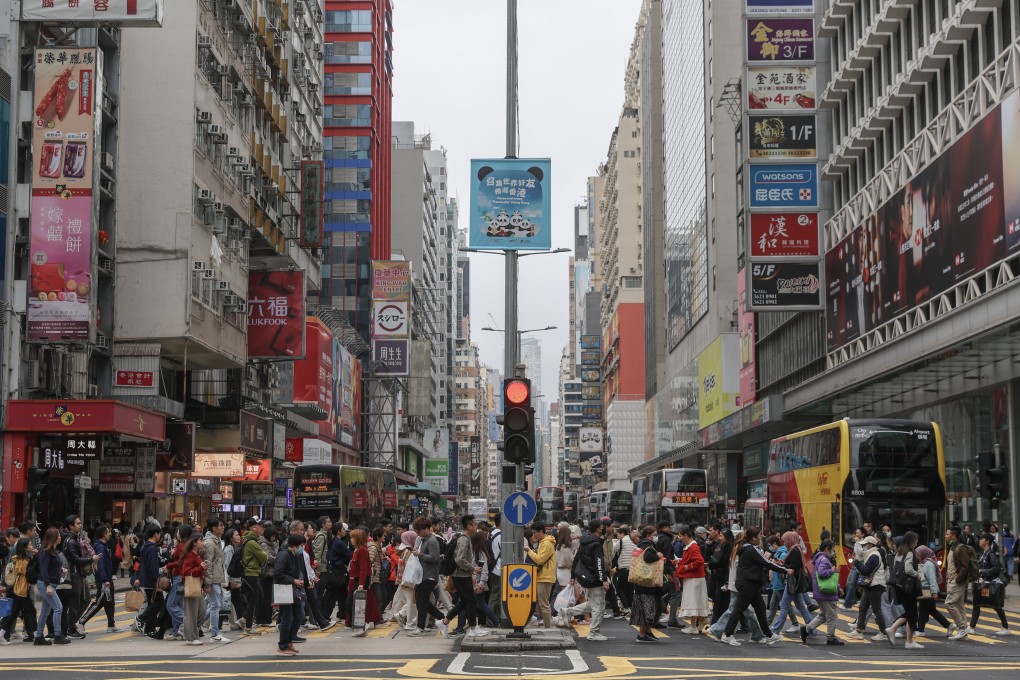 Pedestrians cross Nathan Road in Mong Kok on February 2. The Competition Commission is rolling out a short drama series to help local businesses understand what information can – and cannot – be shared with competitors under the law. Photo: Edmond So