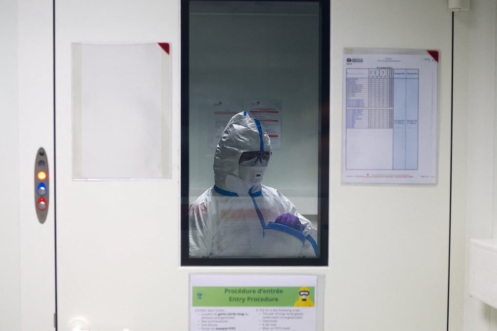 A researcher wearing a protective suit at the Institut Pasteur in Paris, where scientists work to monitor and prevent the spread of avian influenza. Photo: Reuters