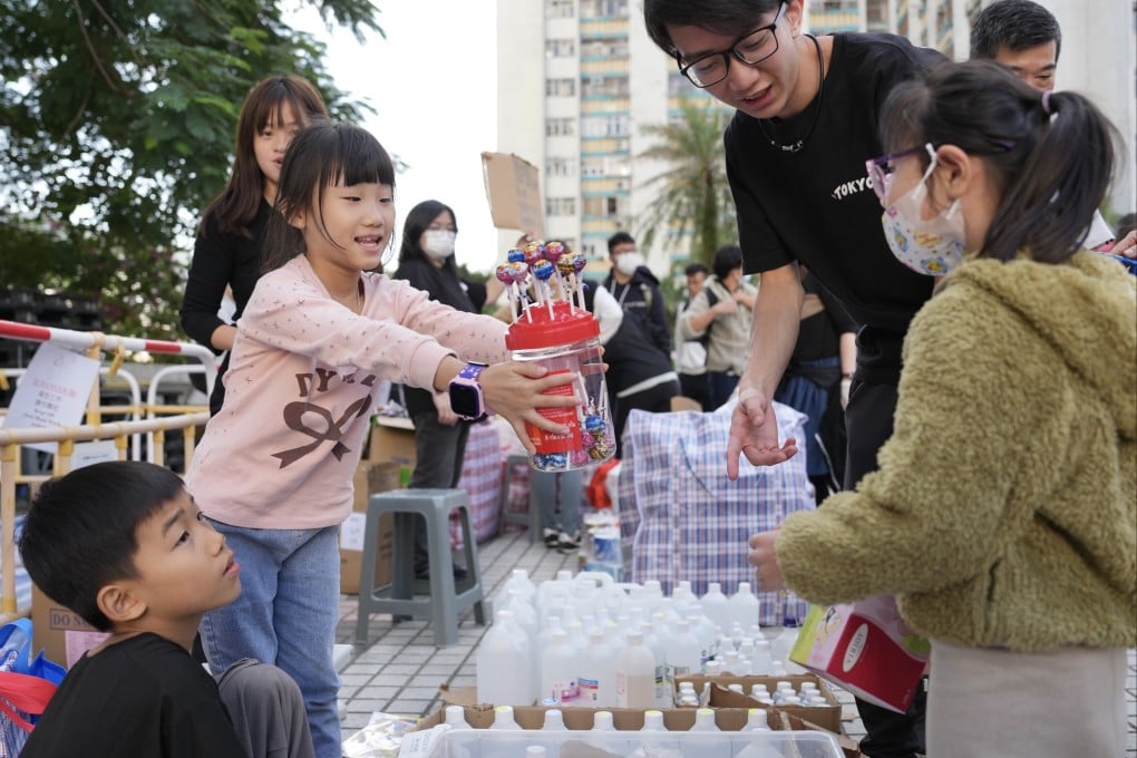 Young volunteers offer candy to children from the affected area. Photo: Karma Lo