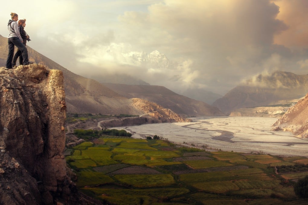 Visitors watch the sunrise in the mountains of Nepal’s Upper Mustang. Photo: Getty Images