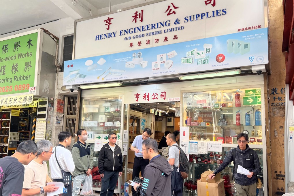 Customers queue outside a fire safety shop in Yau Ma Tei. Photo: Zhao Ziwen