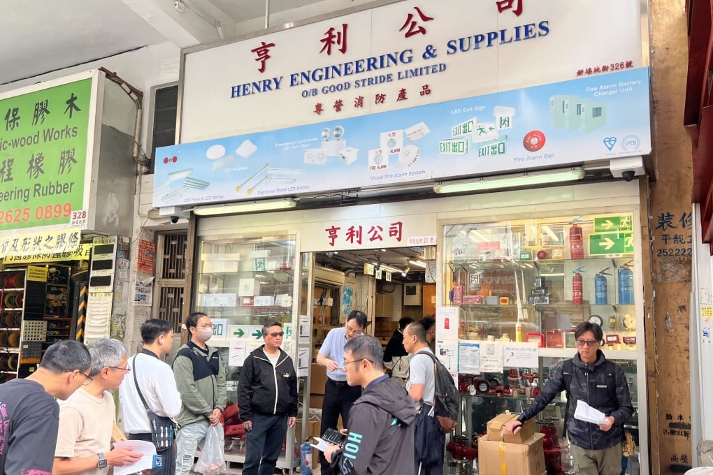 Customers queue outside a fire safety shop in Yau Ma Tei. Photo: Zhao Ziwen