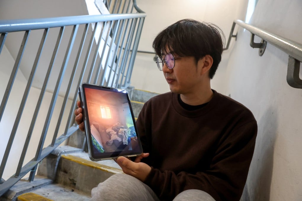 William Li shows a photo taken from inside his flat during the fire on Wednesday. Photo: Edmond So