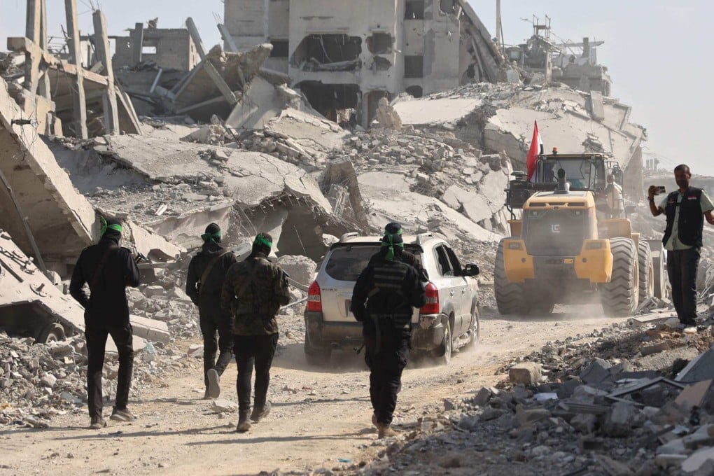 Armed Palestinian Hamas militants follow a digger which has been supplied by Egypt to search for bodies of killed Israeli hostages in Gaza City on November 2. Photo: AFP