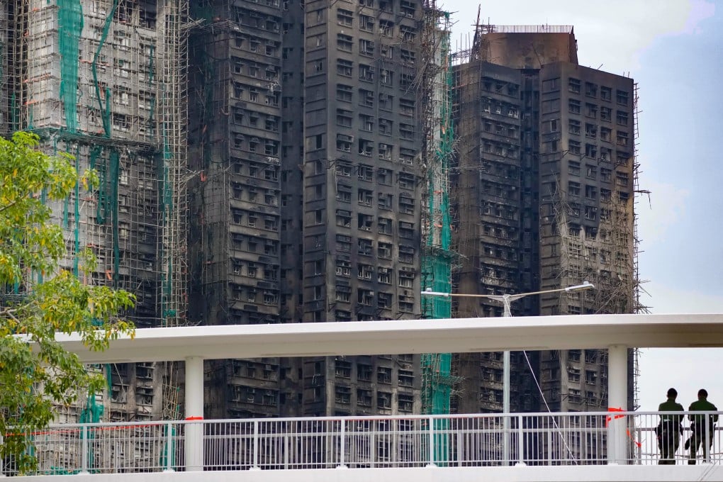 People view the burned buildings at Wang Fuk Court in Tai Po from a pedestrian bridge on November 30, 2025. Photo: Karma Lo