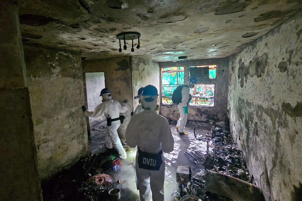 Members of the Disaster Victim Identification Unit   search one of the burned buildings at Wang Fuk Court in Tai Po. Photo: handout