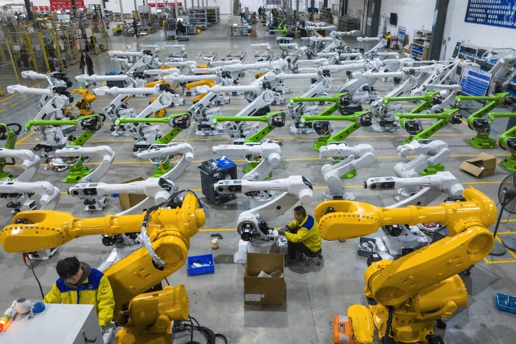 Workers assemble industrial robots at a production facility in China’s central Anhui province. Photo: Getty Images