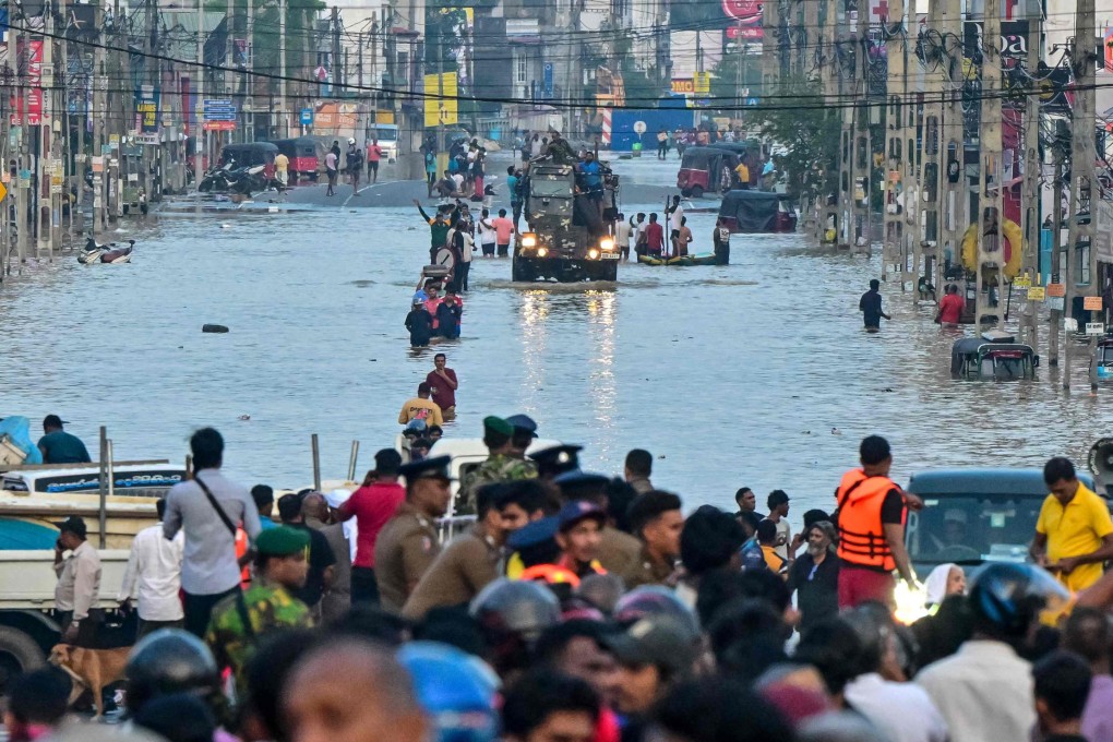 Army personnel ride a truck carrying boats to rescue stranded people in Wellampitiya, on the outskirts of Colombo, Sri Lanka on Sunday. Photo: AFP
