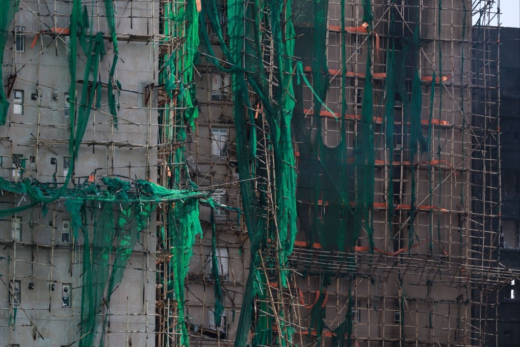 Bamboo scaffolding and mesh covering cling to the burnt-out structure in the aftermath of the Tai Po apartment fire in Hong Kong, on November 28. Photo: Photo: EPA