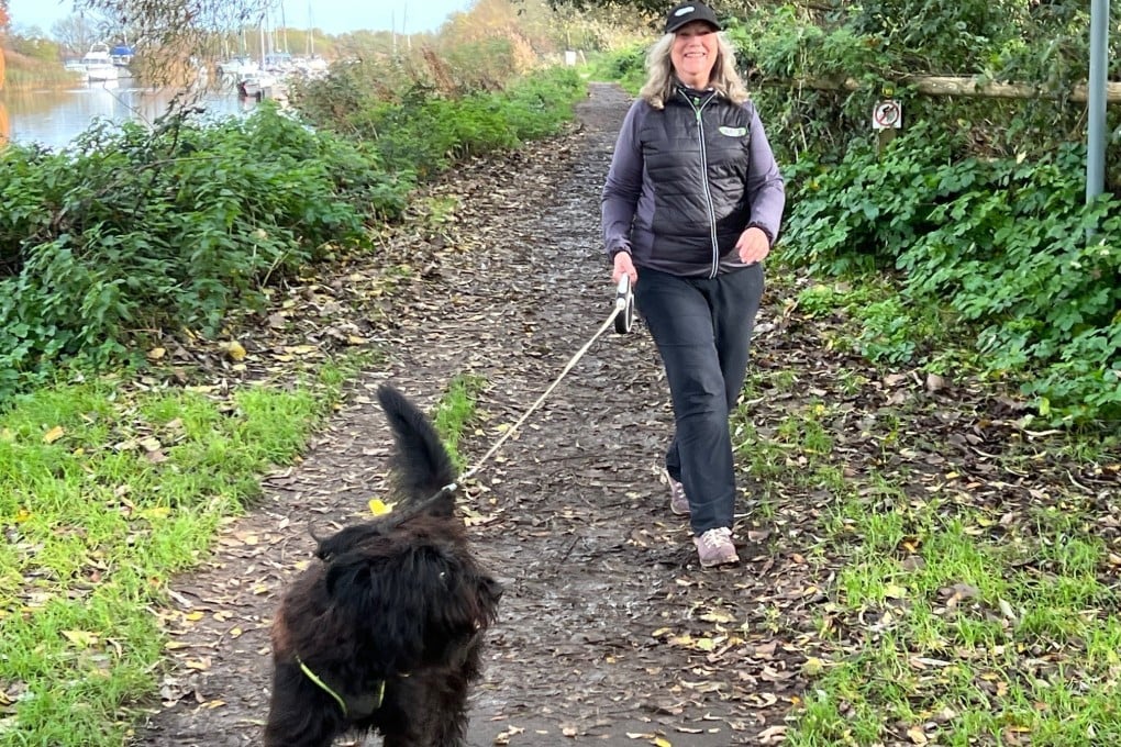 Sports therapist Gill Stewart walks with her dog Bessie. Walking - and physical activity in general - slows the accumulation in the brain of tau, a protein closely tied to the memory decline seen in Alzheimer’s. Photo: Gill Stewart