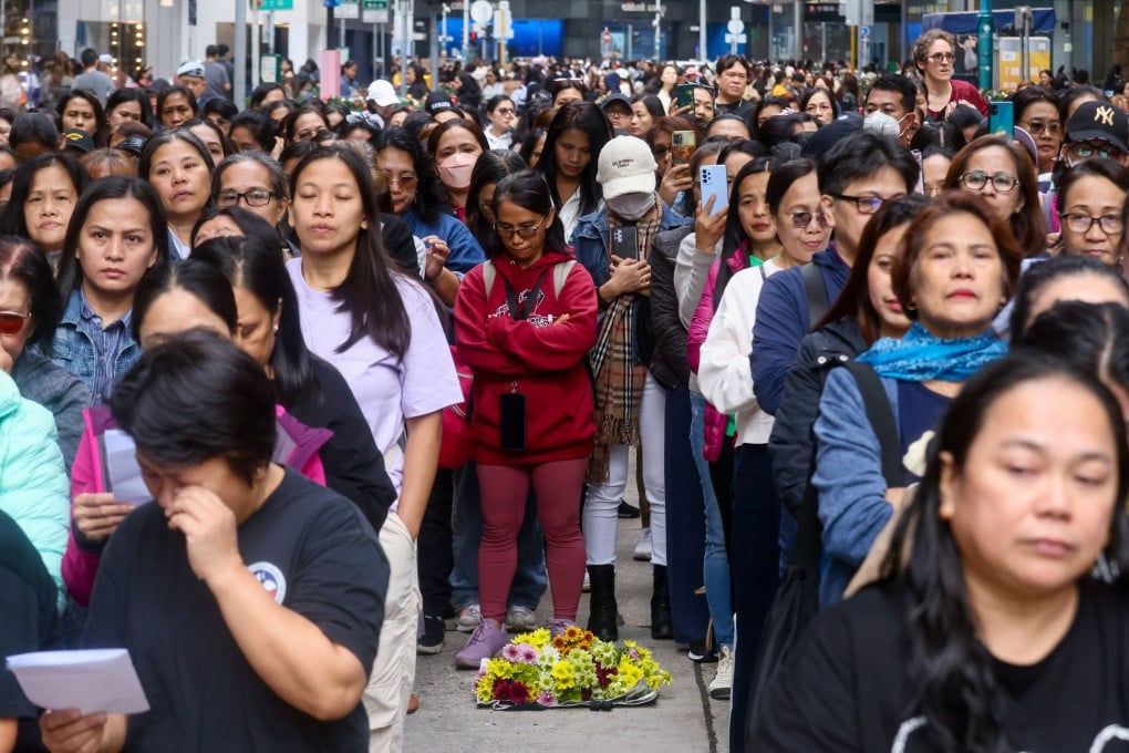 Domestic helpers say prayers at their usual Sunday gathering spot on Chater Road in Central. Photo: Jonathan Wong