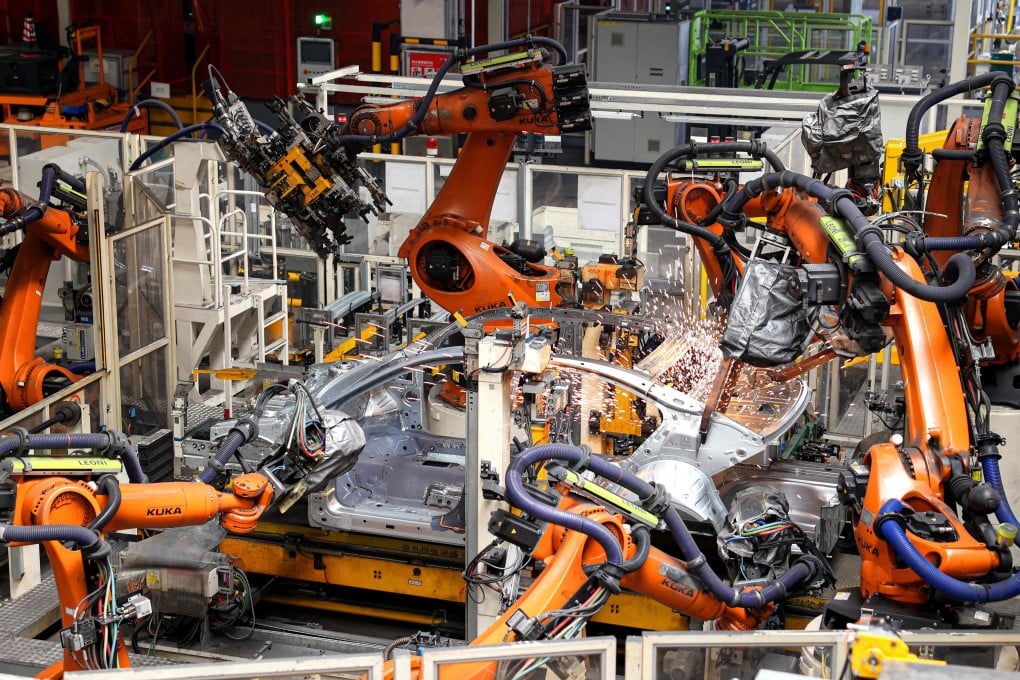 Robot arms are seen at work on a car production line at a factory of FAW-Volkswagen in eastern China’s Shandong province on March 12. Photo: AFP
