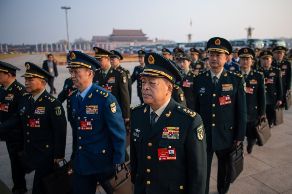 Military delegates walk in Tiananmen Square in Beijing as they arrive for a meeting of the National People’s Congress, China’s top legislature, on March 8. Photo: EPA-EFE