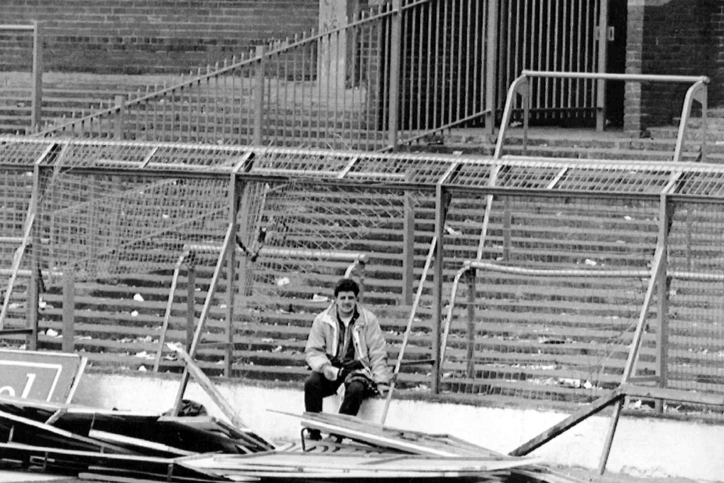 A supporter sits by the damaged fencing at Hillsborough Stadium, in Sheffield, England after the April 15, 1989 tragedy that saw the deaths of 96 football fans and was one of Britain’s worst sporting disasters. Photo: AP