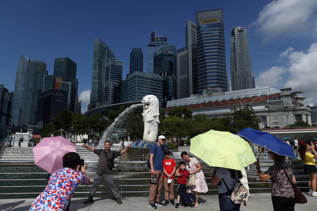 Tourists take photos with the Merlion statue in Singapore. Chinese visitors say the city state is an “easy and comfortable” travel destination. Photo: Reuters