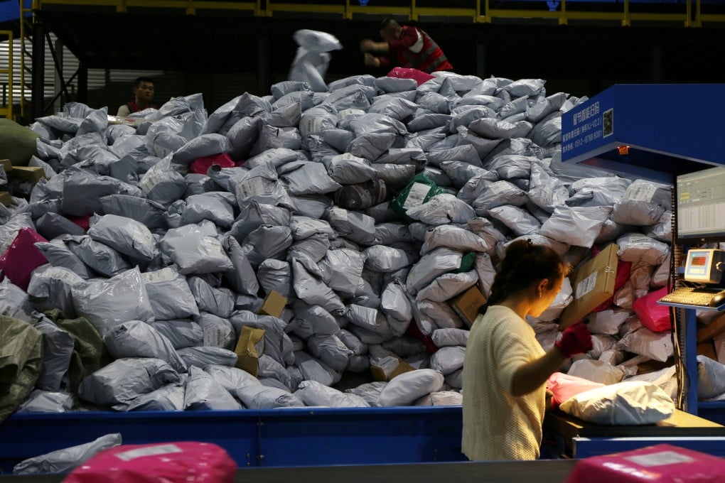 Employees sort parcels at a logistics base in China’s eastern Zhejiang province during the Singles’ Day shopping festival in November 2019. China’s consumers continue to turn to e-commerce platforms to find cut-price deals. Photo: Reuters