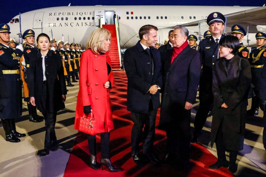 China’s Foreign Minister Wang Yi welcomes France’s President Emmanuel Macron and his wife Brigitte to Beijing. Photo: Reuters