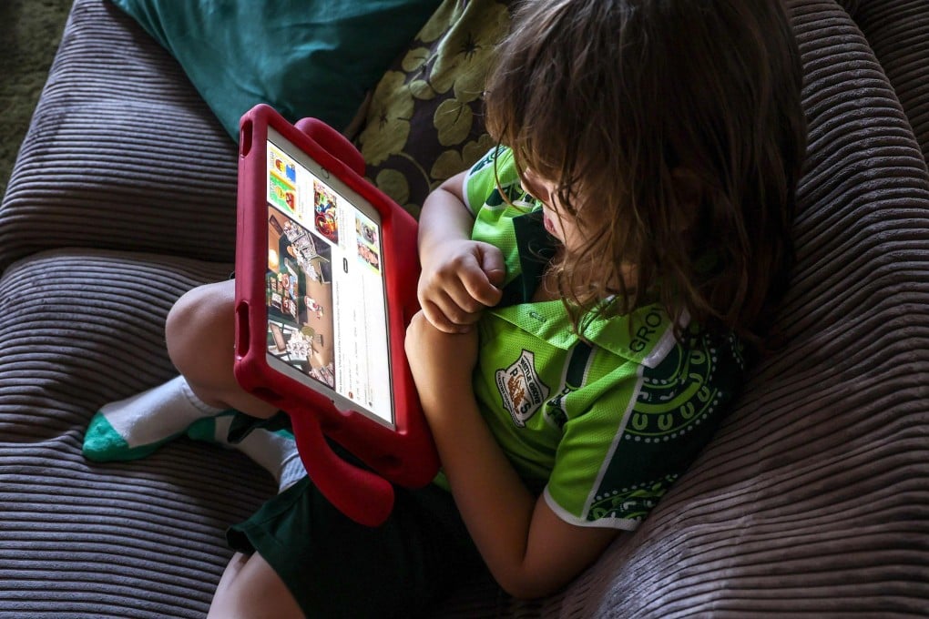 Six-year-old Enrique Navarro watches a show on YouTube at his home in western Sydney on October 30. Photo: AFP