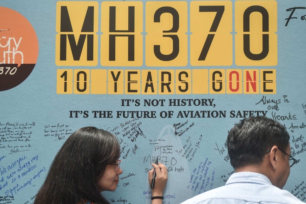A woman writes a message during an event held by relatives of missing passengers and supporters to mark the 10th anniversary of the disappearance of MH370 on March 3, 2024. Photo: AFP