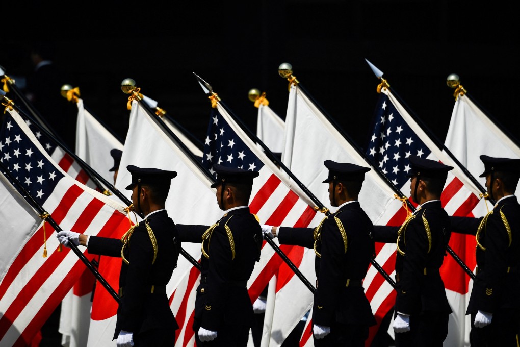 Soldiers hold US and Japanese flags during a welcome ceremony for US President Donald Trump at the Imperial Palace in Tokyo in 2019. Photo: AFP