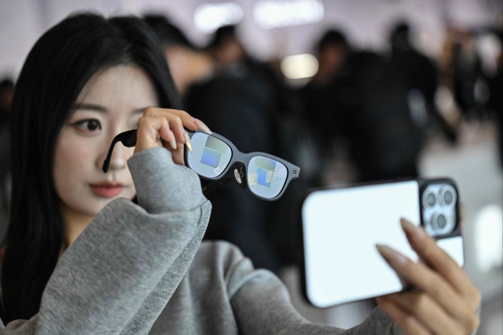 A woman checks a pair of Rokid glasses with display and camera using artificial intelligence and augmented reality during a presentation event in Hangzhou, in eastern Zhejiang province, on November 13. Photo: AFP