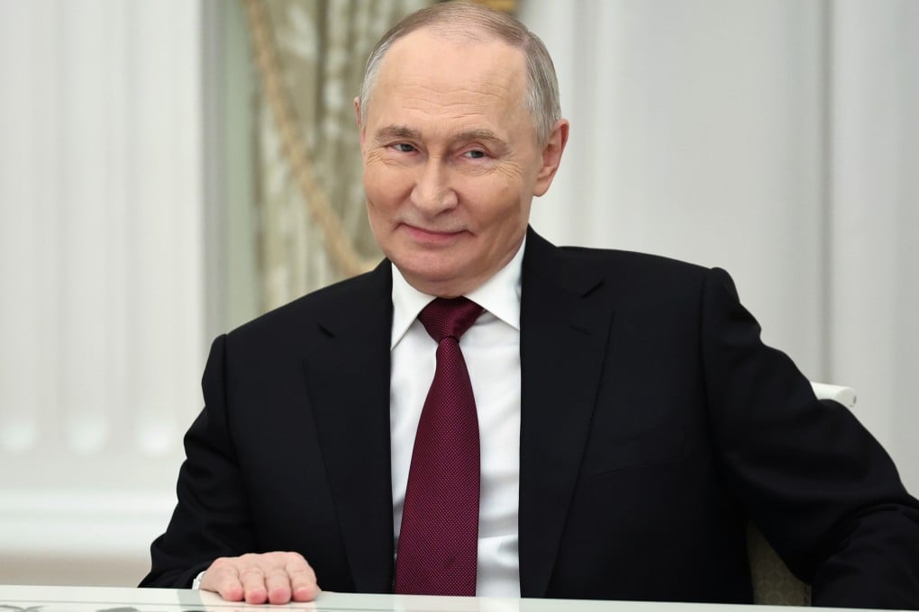 Russian President Vladimir Putin smiles as he meets the US delegation at the Kremlin on Tuesday. Photo: Sputnik via AP