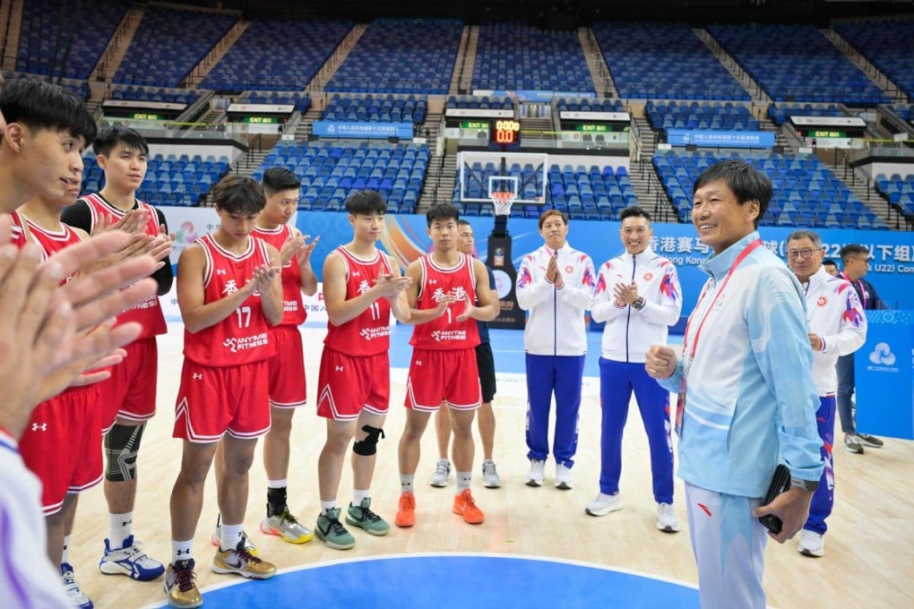 Yeung Tak-keung (right) with the city’s men’s under-22 basketball team at Hong Kong Coliseum. Photo: Handout