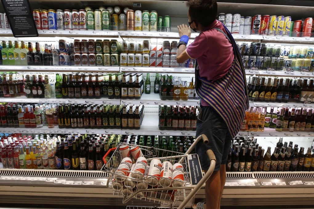 A customer shops for alcoholic beverages at a grocery store in Bangkok. Photo: EPA-EFE